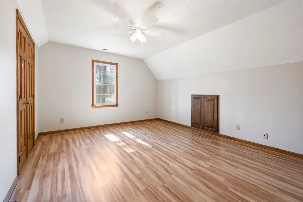 Example after: bright room with new wood-look flooring and fresh paint